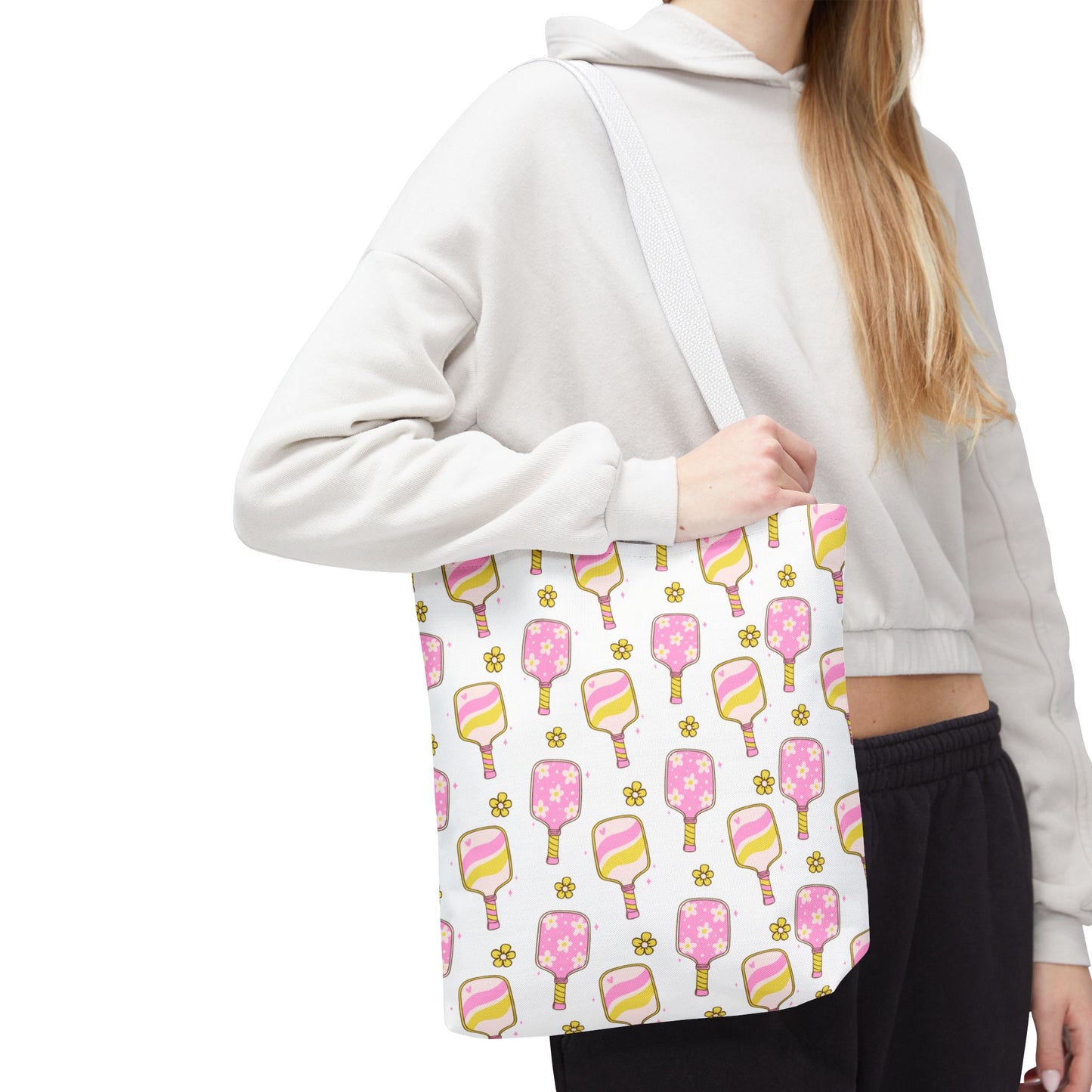 white polyester tote bag with pattern of light pink and yellow pickleball paddles