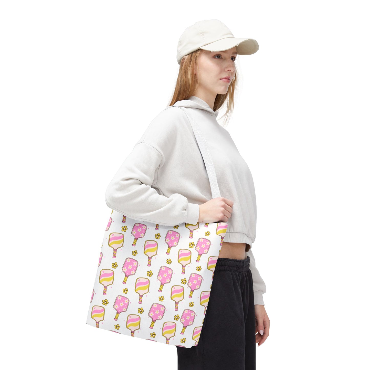 white polyester tote bag with pattern of light pink and yellow pickleball paddles