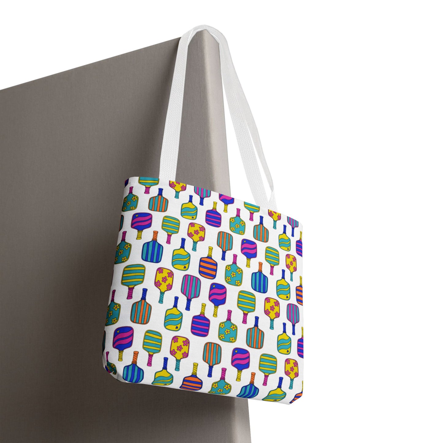 white tote bag with colorful pattern full of the best pickleball paddles