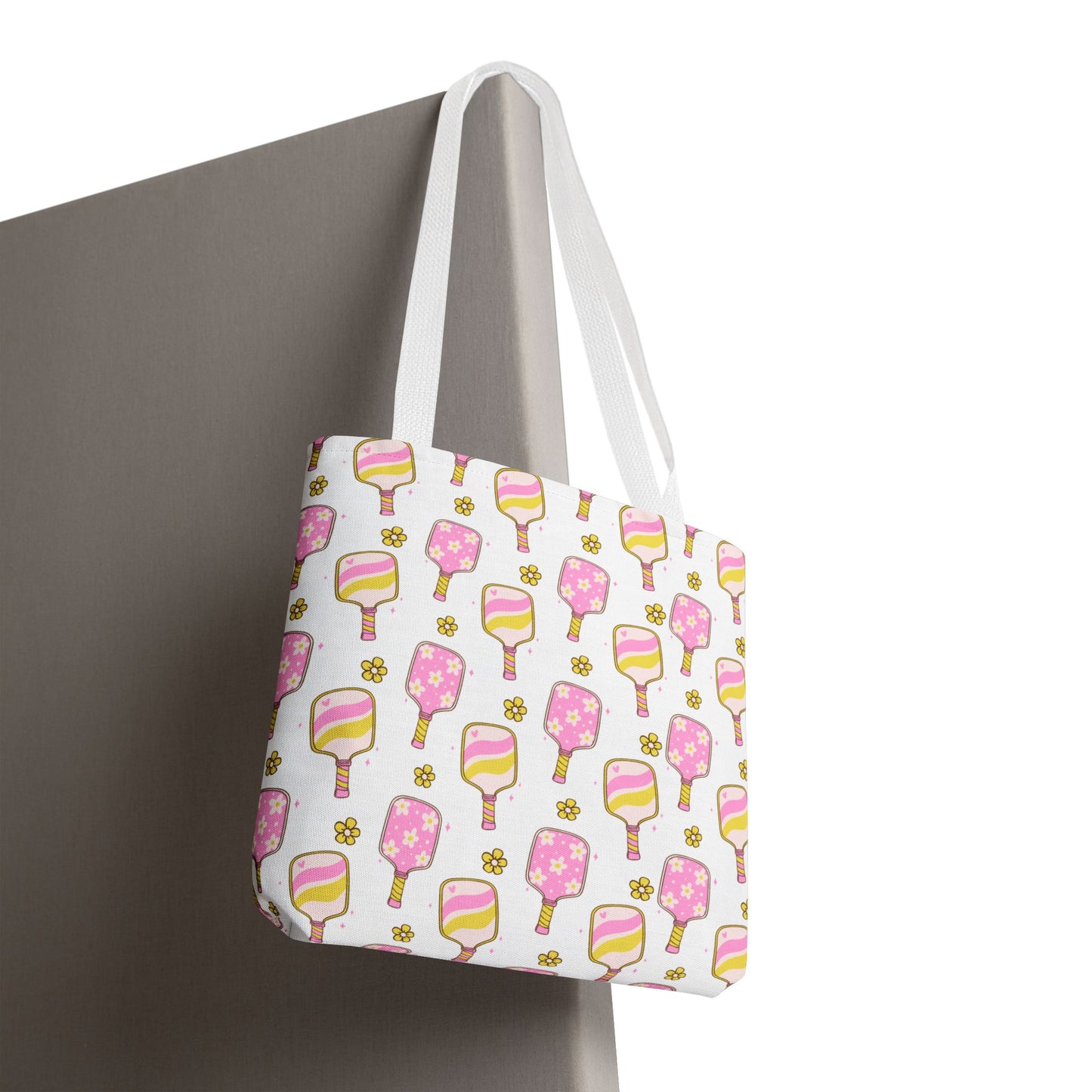 white polyester tote bag with pattern of light pink and yellow pickleball paddles