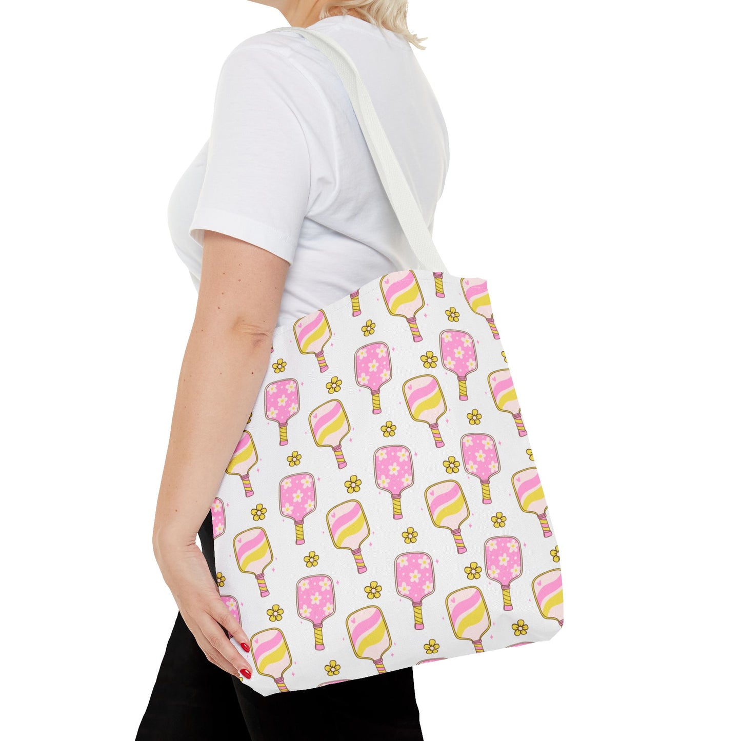white polyester tote bag with pattern of light pink and yellow pickleball paddles