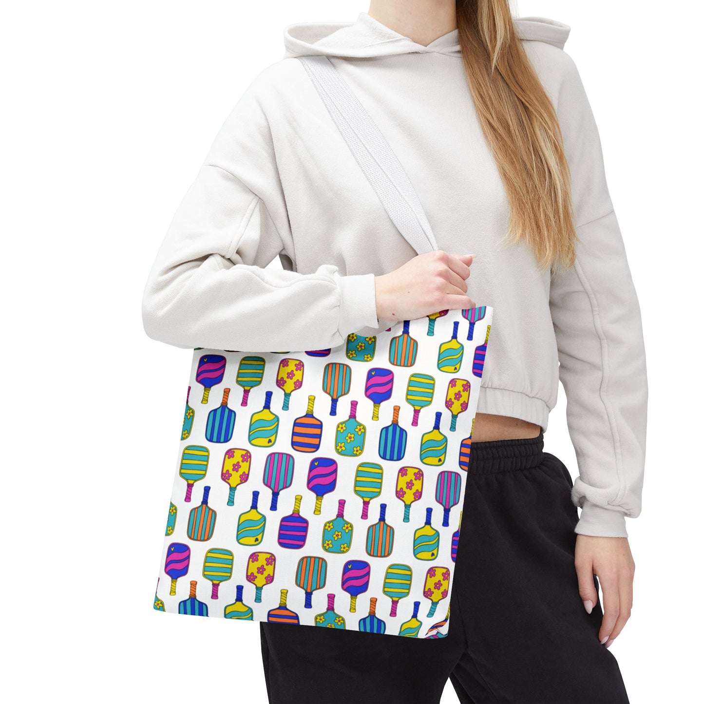 white tote bag with colorful pattern full of the best pickleball paddles