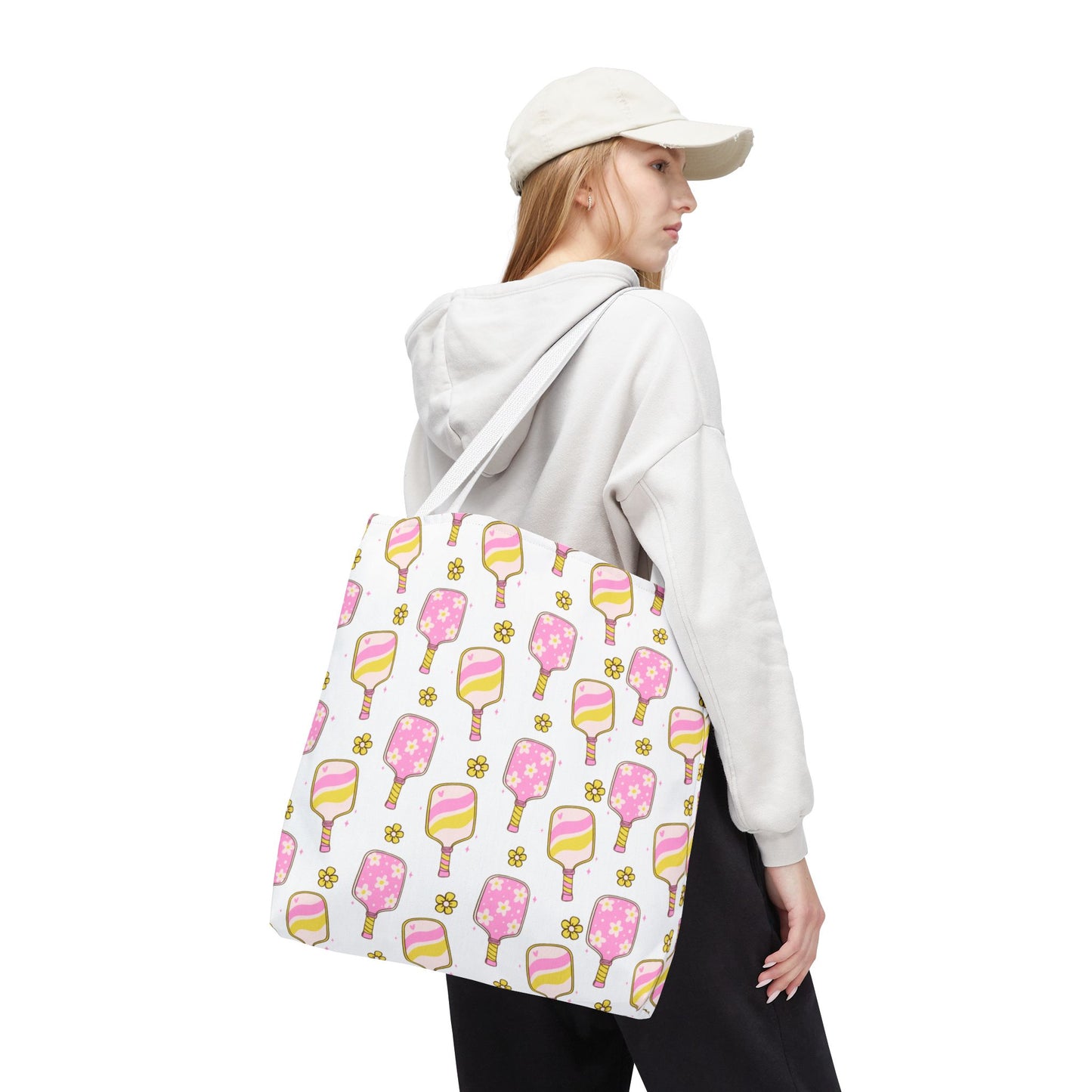 white polyester tote bag with pattern of light pink and yellow pickleball paddles