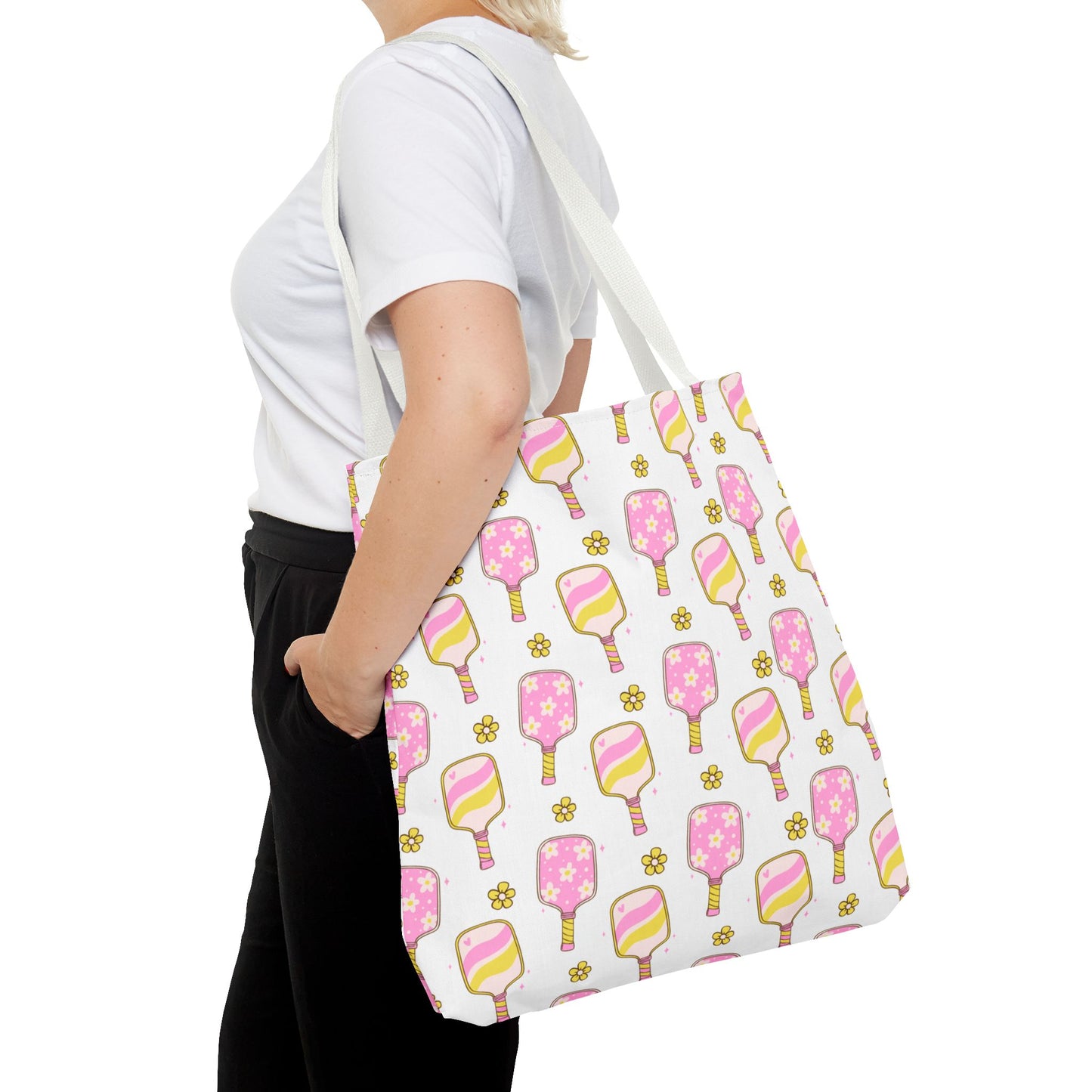 white polyester tote bag with pattern of light pink and yellow pickleball paddles