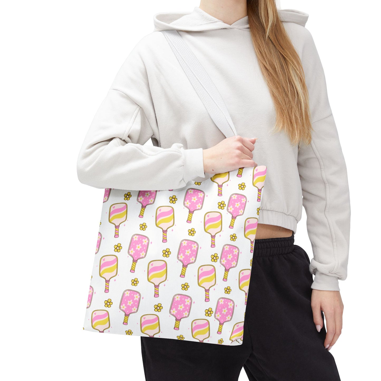 white polyester tote bag with pattern of light pink and yellow pickleball paddles