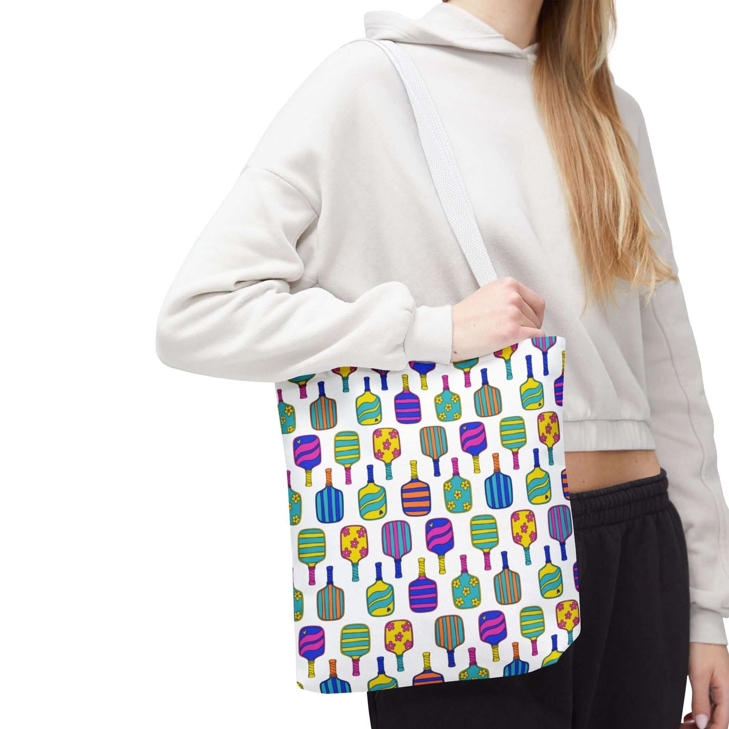 white tote bag with colorful pattern full of the best pickleball paddles