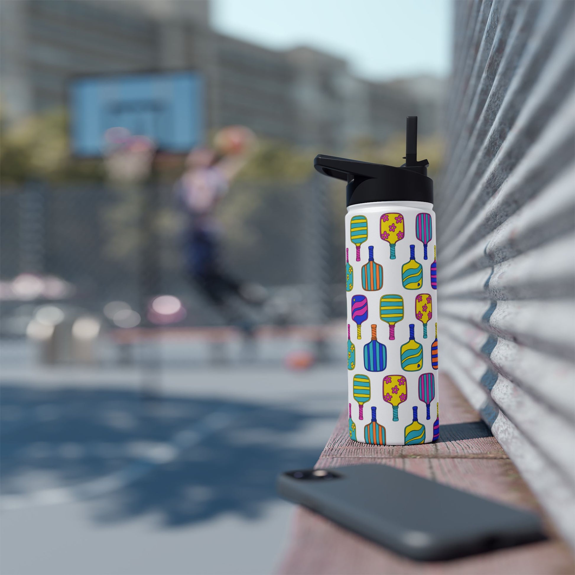 White stainless steel waterbottle with flip top patterned with bright colorful pickleball patterns