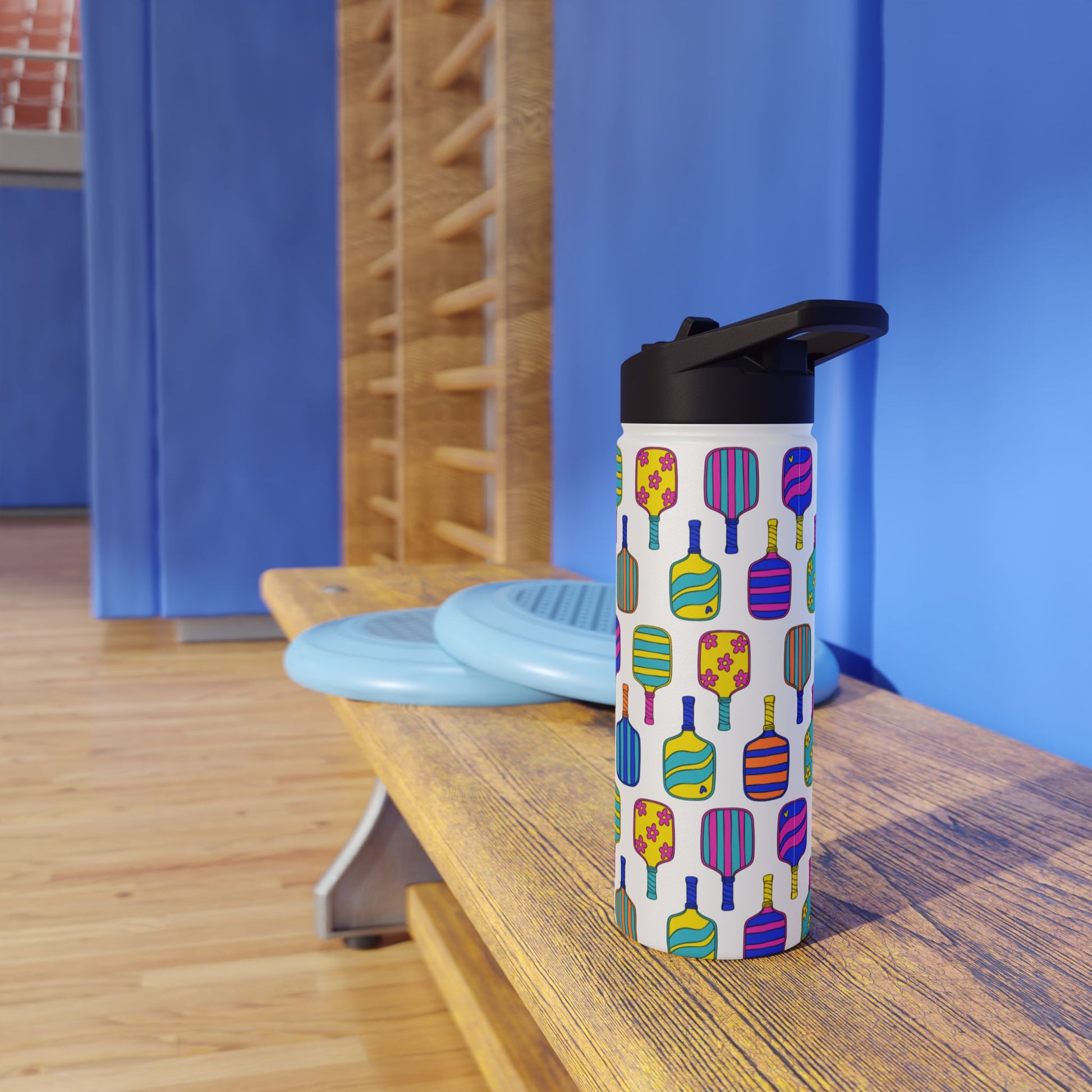 White stainless steel waterbottle with flip top patterned with bright colorful pickleball patterns