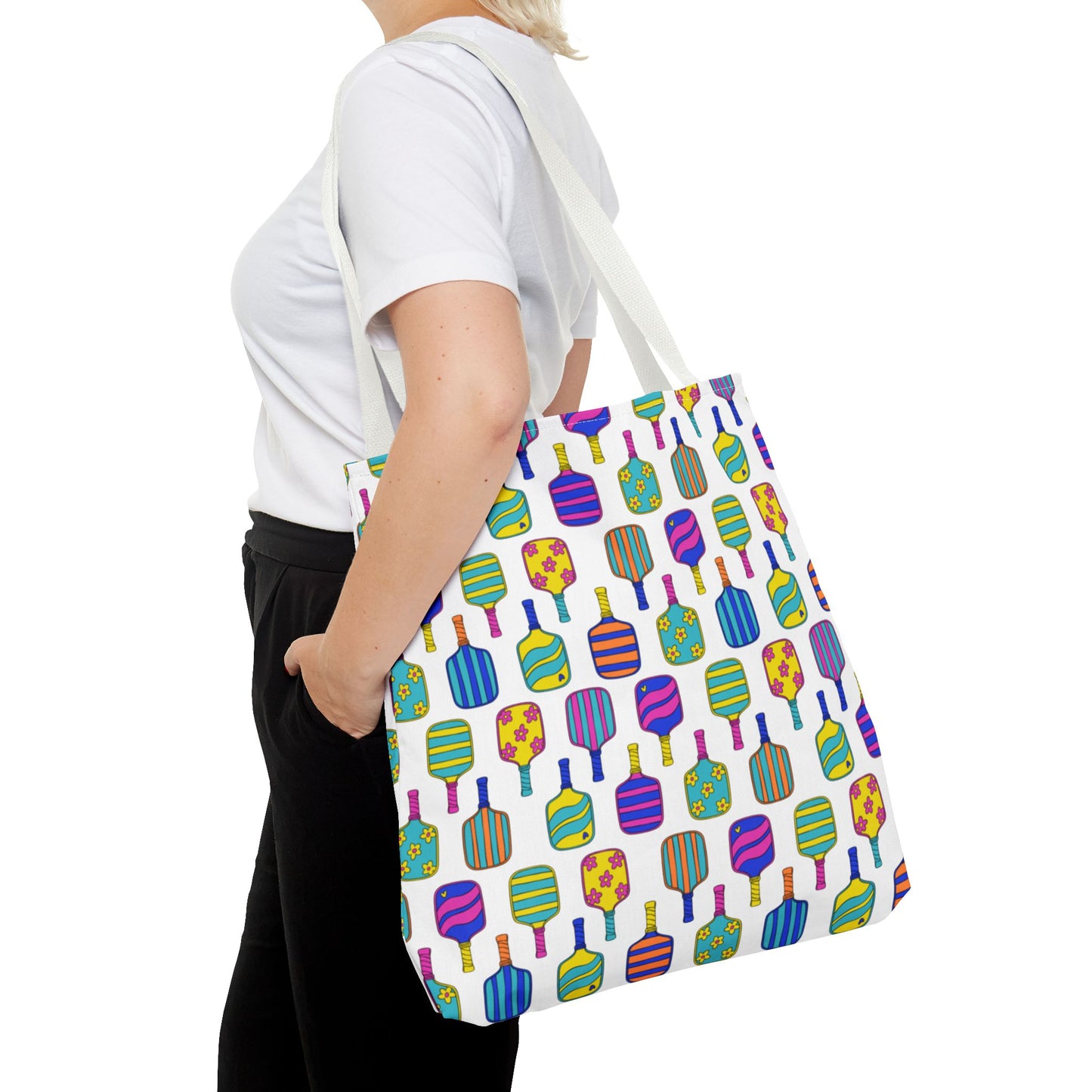 white tote bag with colorful pattern full of the best pickleball paddles