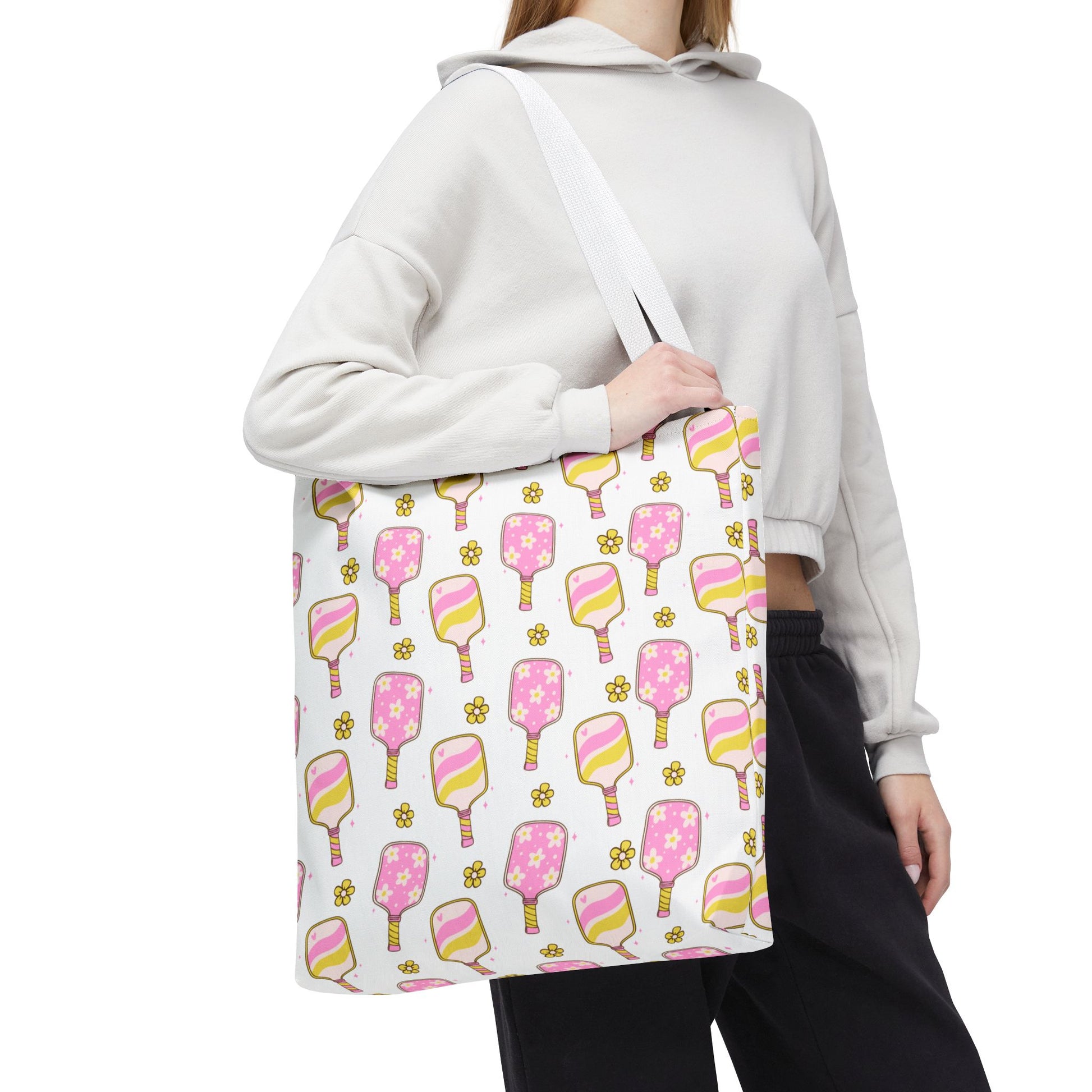 white polyester tote bag with pattern of light pink and yellow pickleball paddles