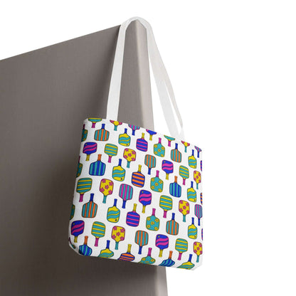 white tote bag with colorful pattern full of the best pickleball paddles