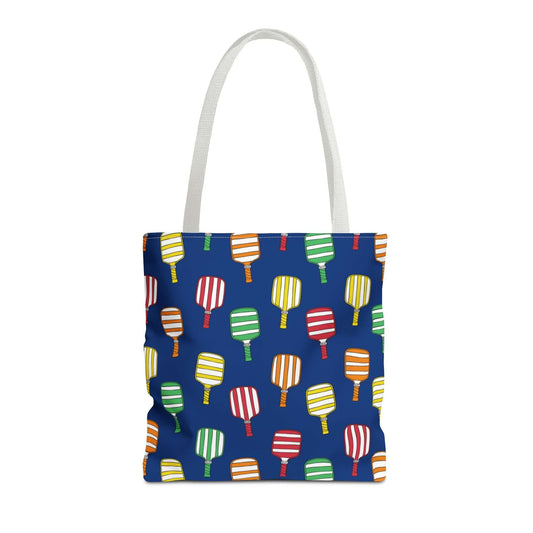 sturdy totebag with navy background and colorful pickleball paddles pattern on entire bag. white handle.