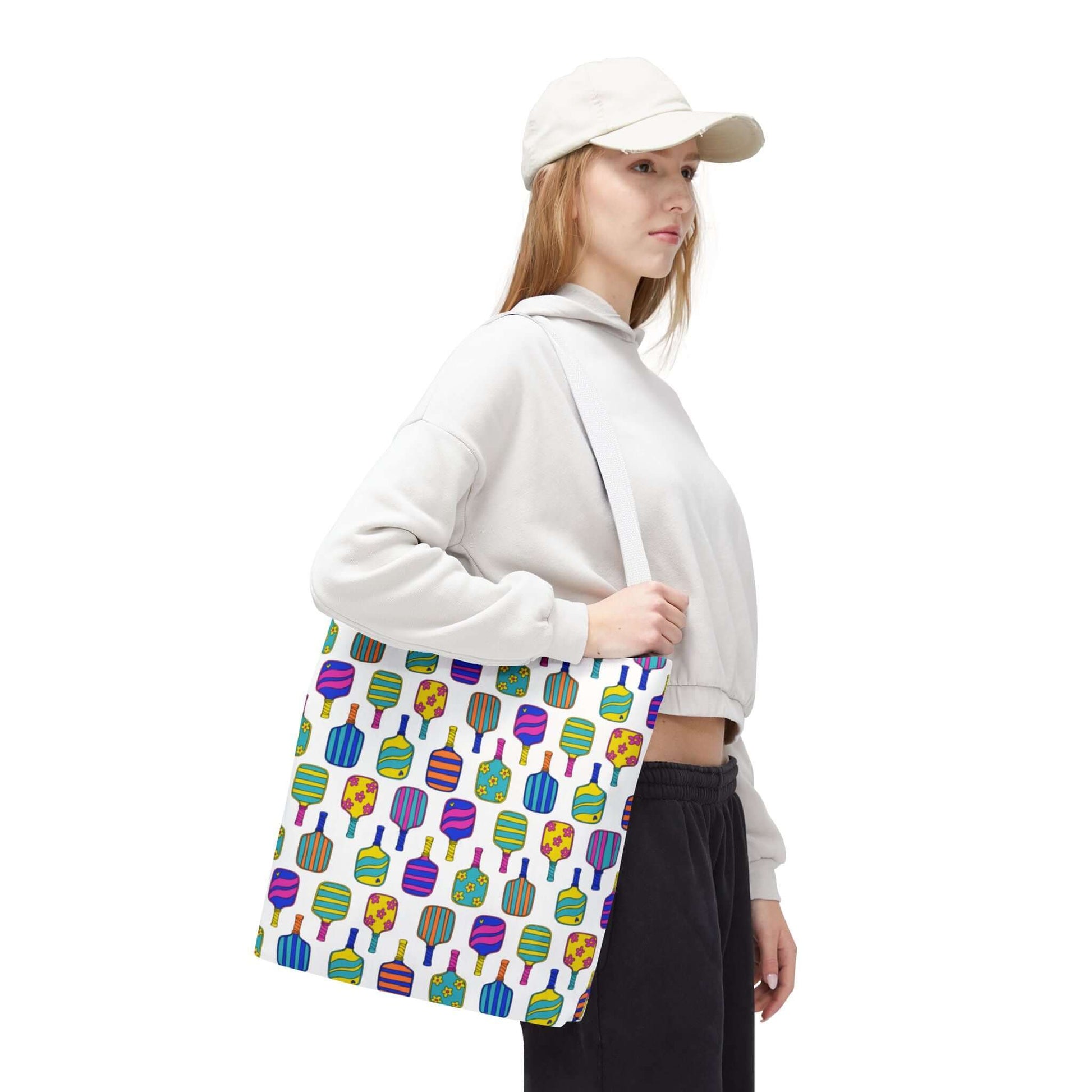white tote bag with colorful pattern full of the best pickleball paddles
